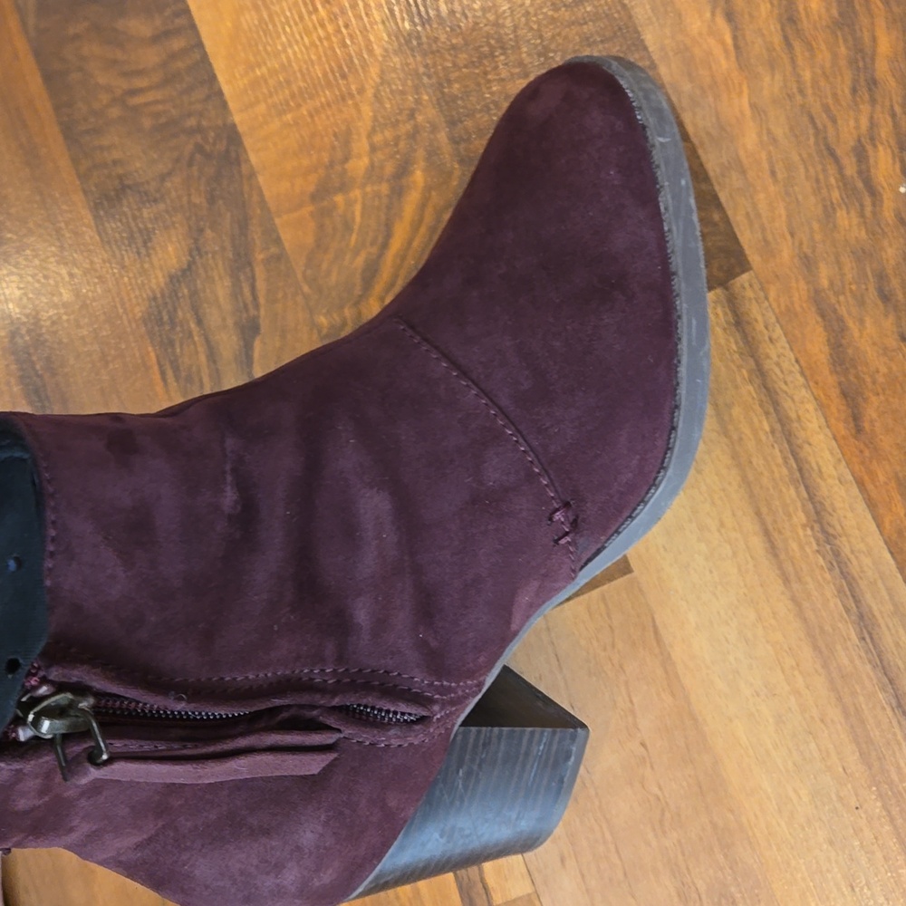 Maroon zippered ankle boots.